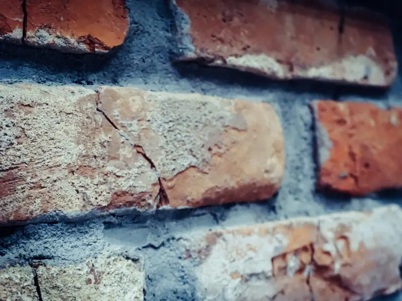 Brick wall showing cracks beginning to form.