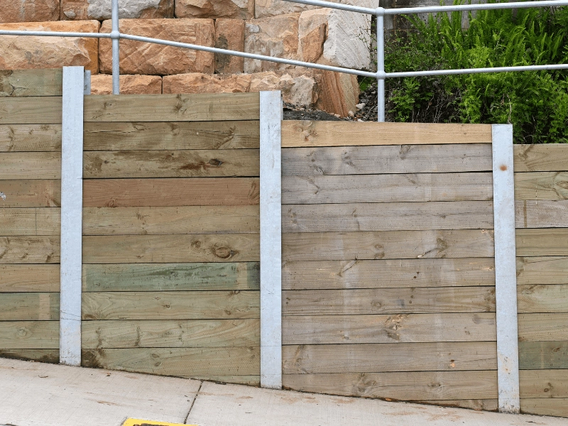 A retaining wall with support beams to maintain structural integrity.