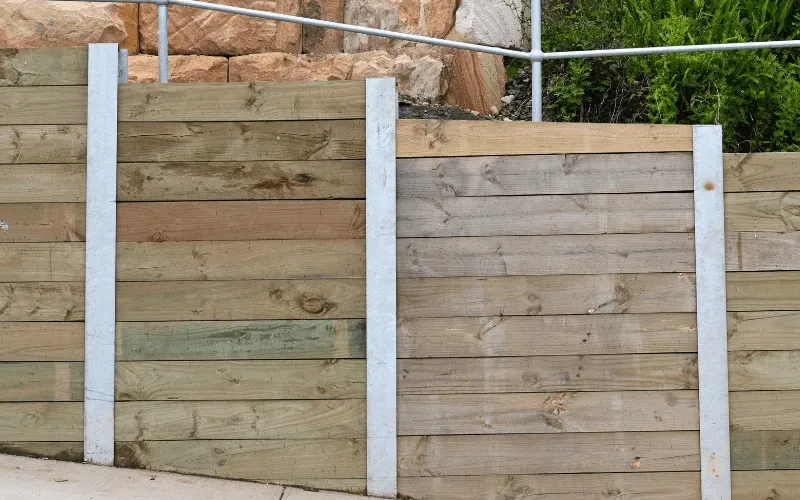 A retaining wall with support beams can also be used to strengthen property integrity and prevent shifting soil.