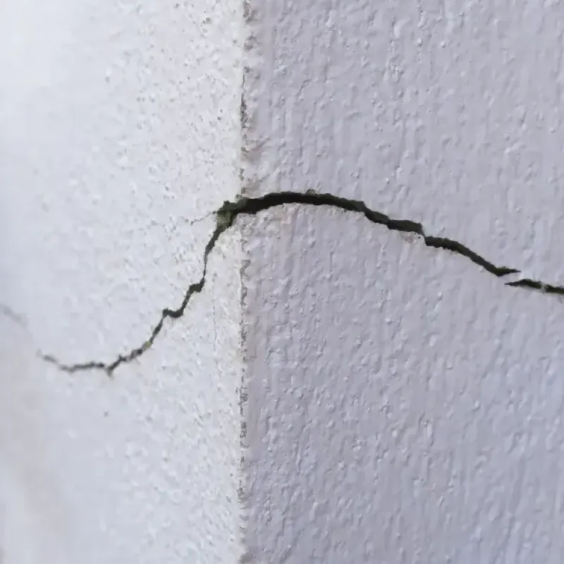 Foundation stress cracks caused by soil erosion.