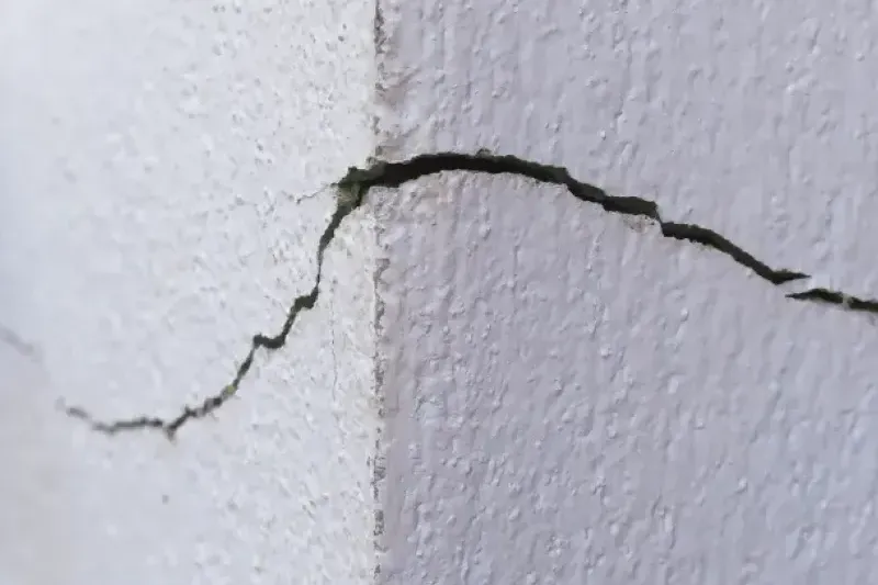 Foundation stress cracks caused by soil erosion.