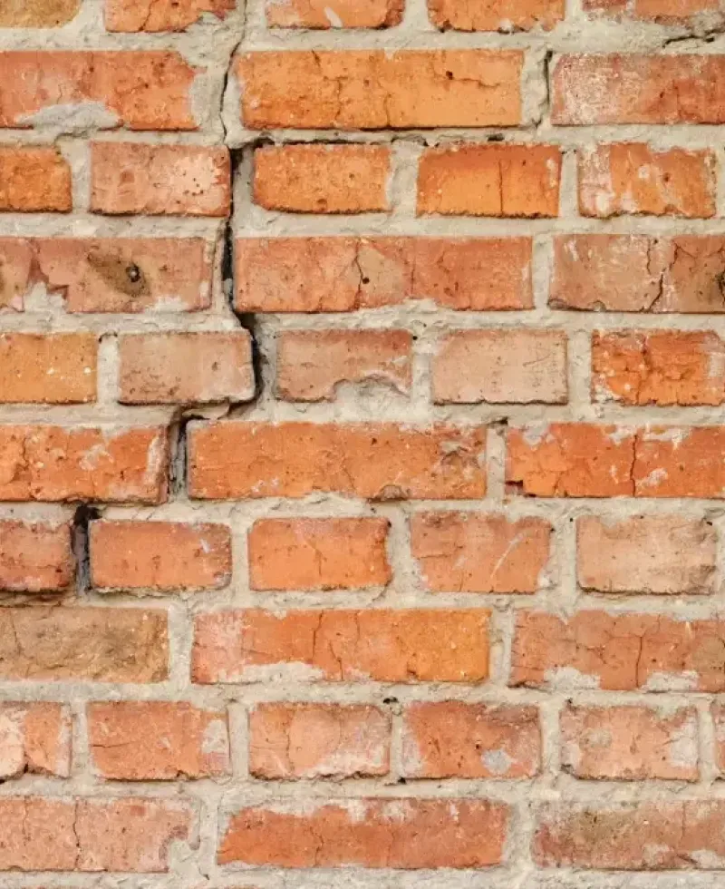 Brick wall cracking showing signs of a foundation problem.